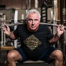 Rudy Kadlub lifts a barbell over his shoulders