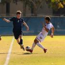 Adam Mickelson (2) dribbles the ball downfield during the playoff soccer match between UC Davis and Louisville on November 24, 2019.