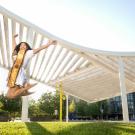 UC Davis Senior and Strategic Communications intern Anisa Luong jumps in front of the Shrem Museum on May 1, 2021.