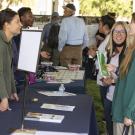 A student and parent talking with a campus representative at last year’s Aggie Day event.