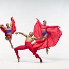 Dancers on white stage dressed in red costumes