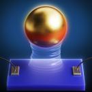 A shiny gold sphere hovers above a blue rectangular plate. Wires are attached to the plate at left and right. 