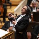 Man in tux directing symphony