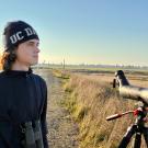 Birder Julian Johnson with spotting scope at treatment plant pond and grassland