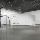 Installation view of tall sculpture with spiral staircase