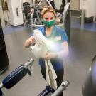 Student disinfects workout equipment at the ARC.