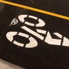 Closeup photo of asphalt with the bike lane symbol painted on it.