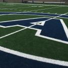 "CA" athletics logo painted on 50-year line of football field