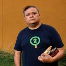 Man holds maize in environmental portrait