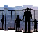 Photo illustration of silhouetted people standing in front of a border fence.