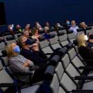 People sit in a dark planetarium