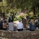 People on seating wall, in a circle