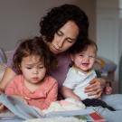 Mother reading to two toddlers 