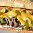 "Ultimate Philly" sandwich: lunch meat, onions, peppers, nacho cheese, on French roll