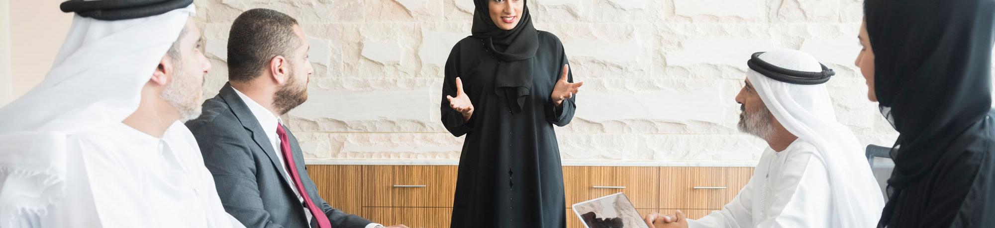 A female gives a presentation to her colleagues