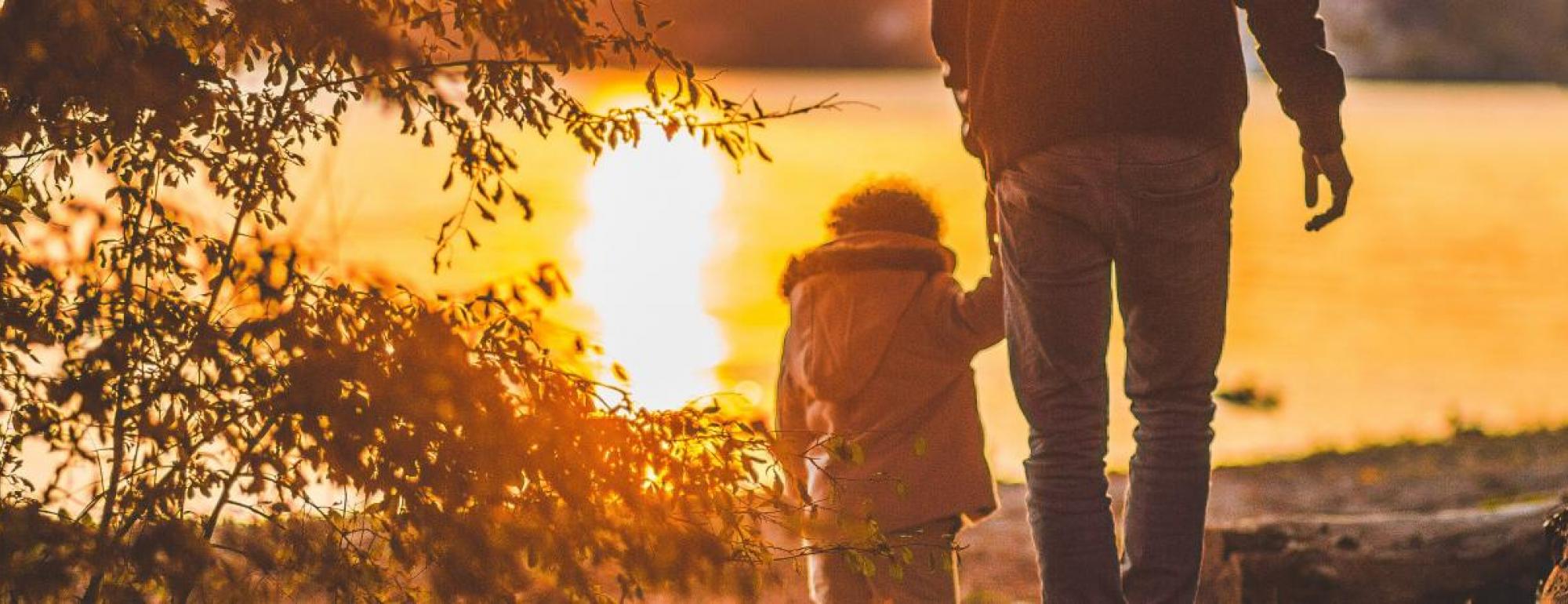 adult walks with young child hand in hand