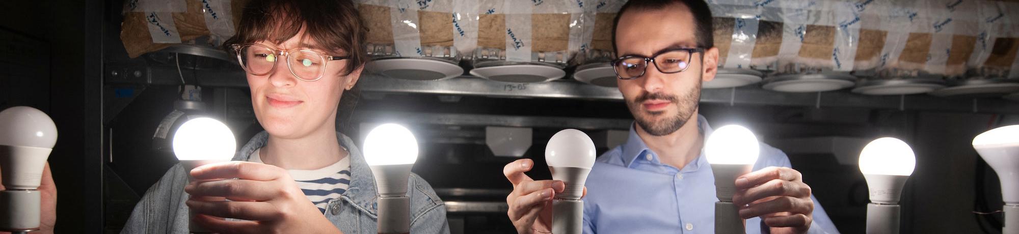 Two students adjusting several LED lights