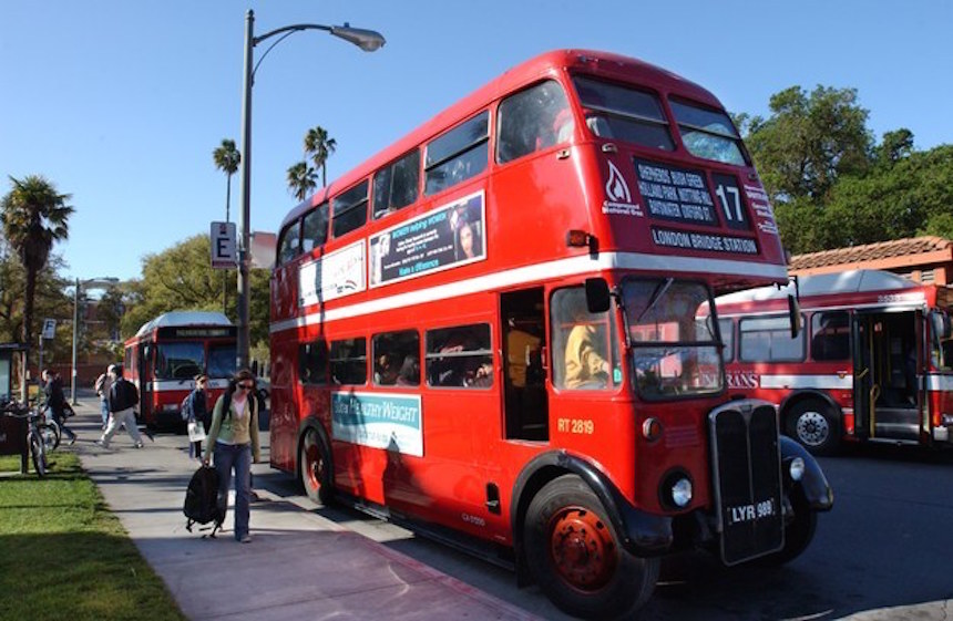 Red double decker Unitrans bus parked at bus terminal