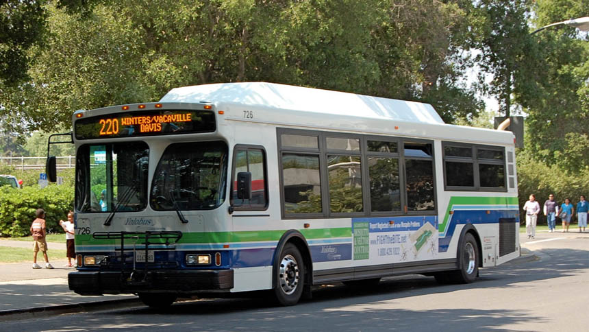 Yolobus bus at a stop on a residential street