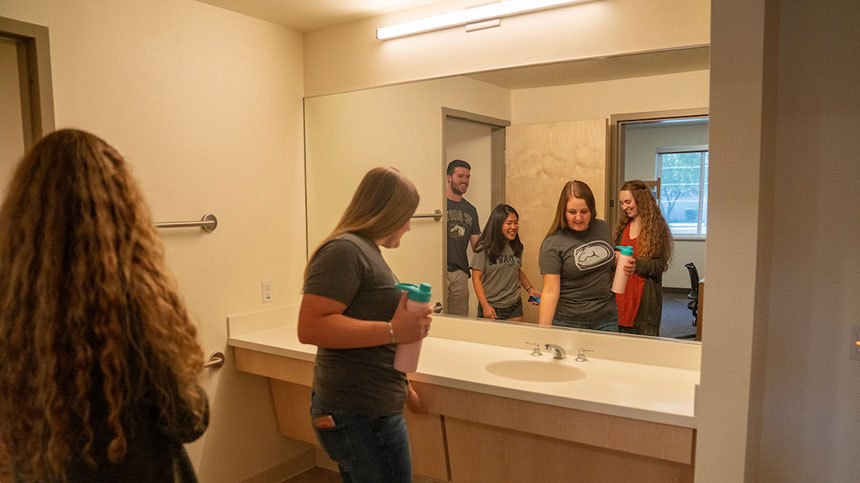 Four students checking out a restroom