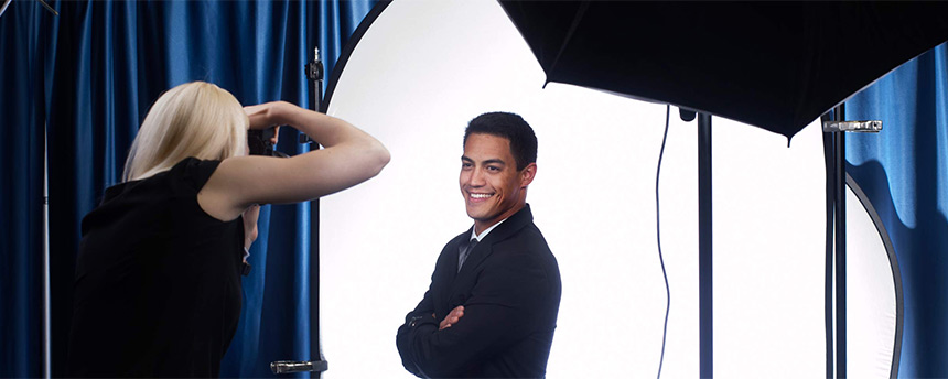 Man getting his photo shot professionally by a female photographer